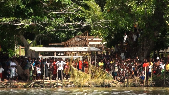 Villagers of Pere village wait on shore for the Climate Challenger and crew. (photo: still from video)